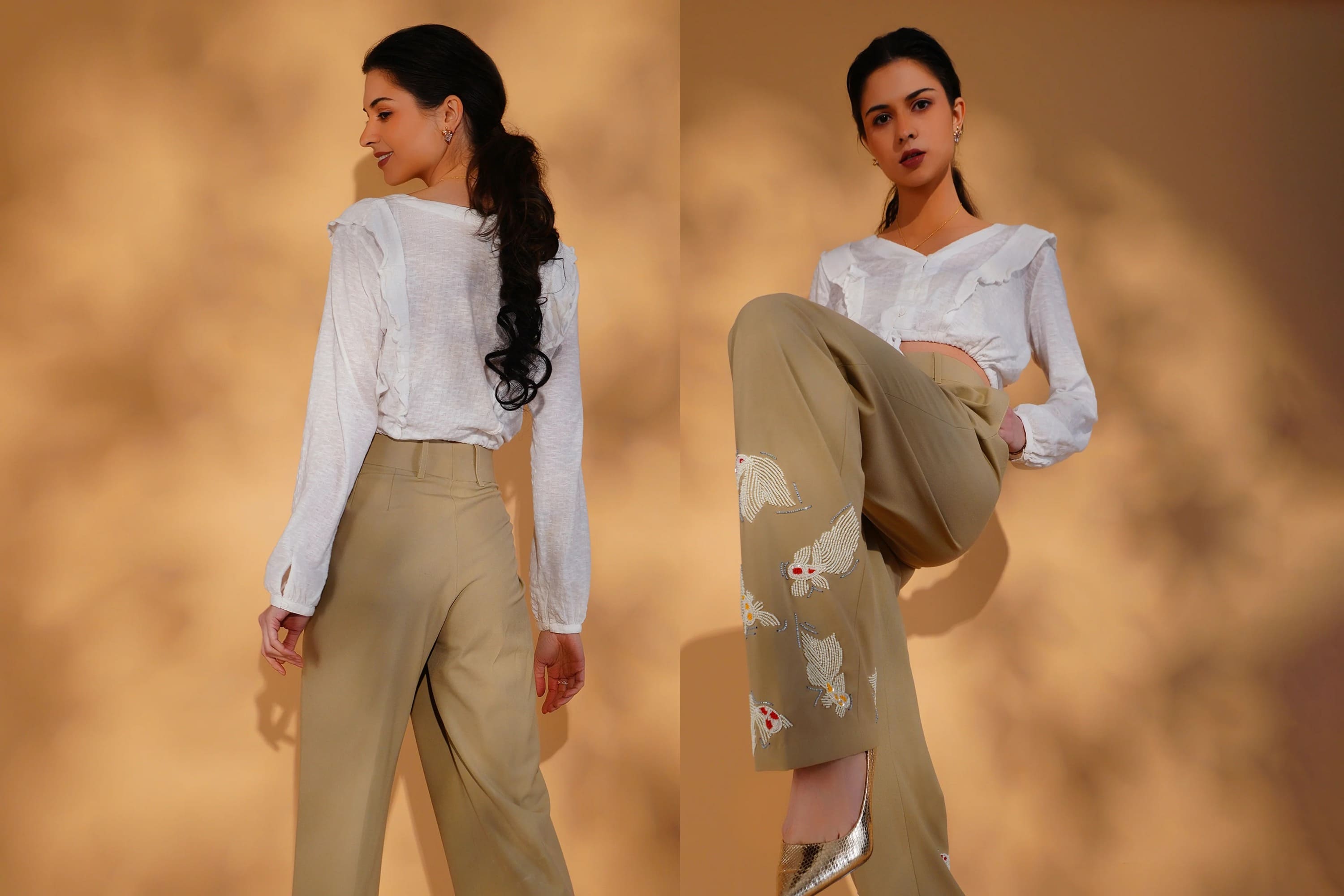 Woman wearing a white blouse and beige pants with floral design against a warm-toned background