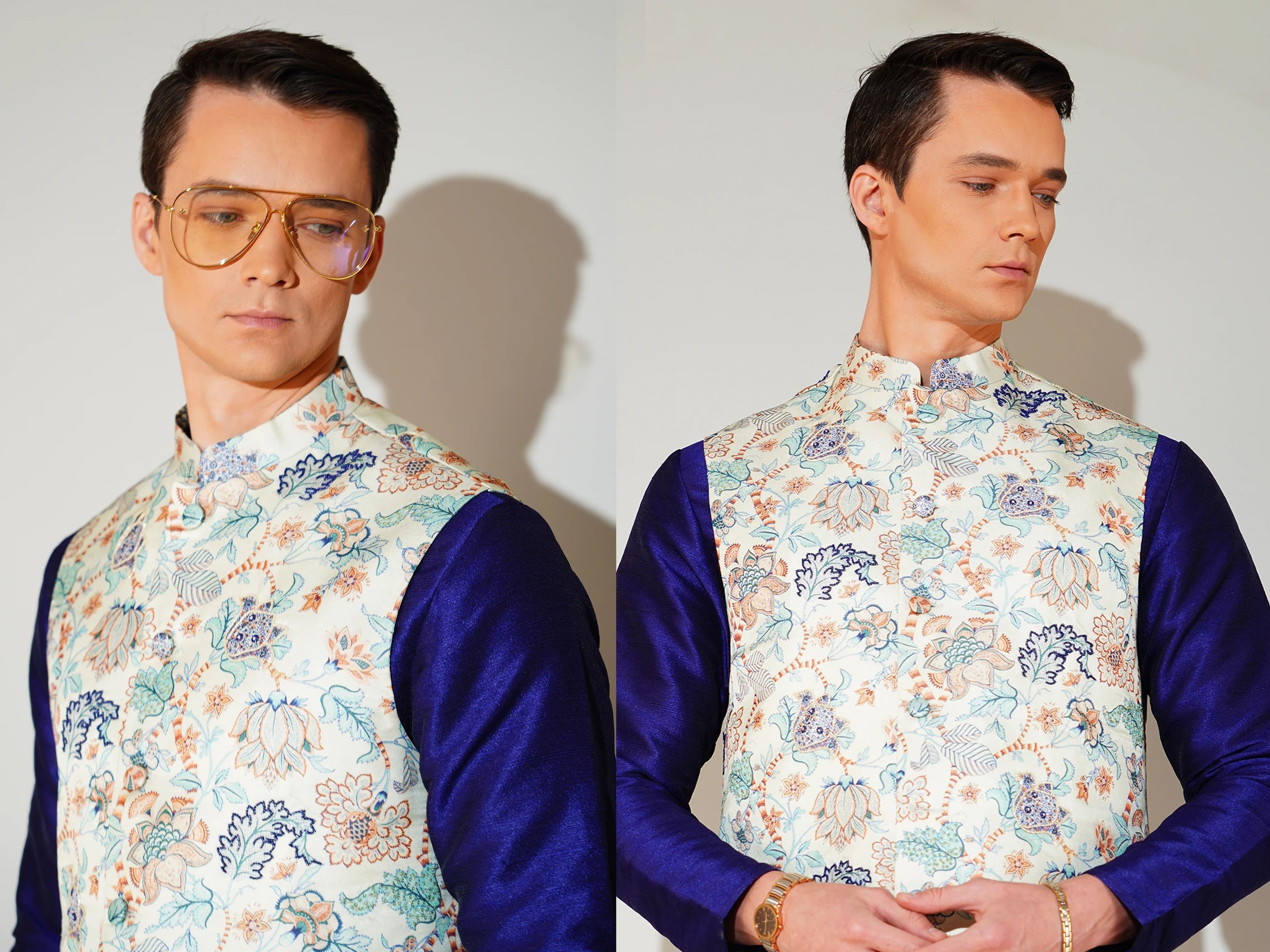 Man wearing a floral vest over a blue shirt against a white background
