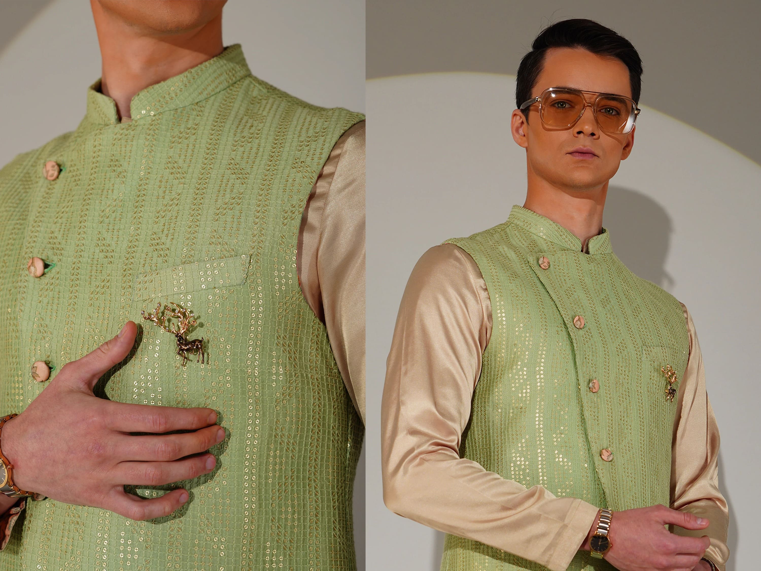 Man wearing a green embroidered vest over a beige shirt with a plain background
