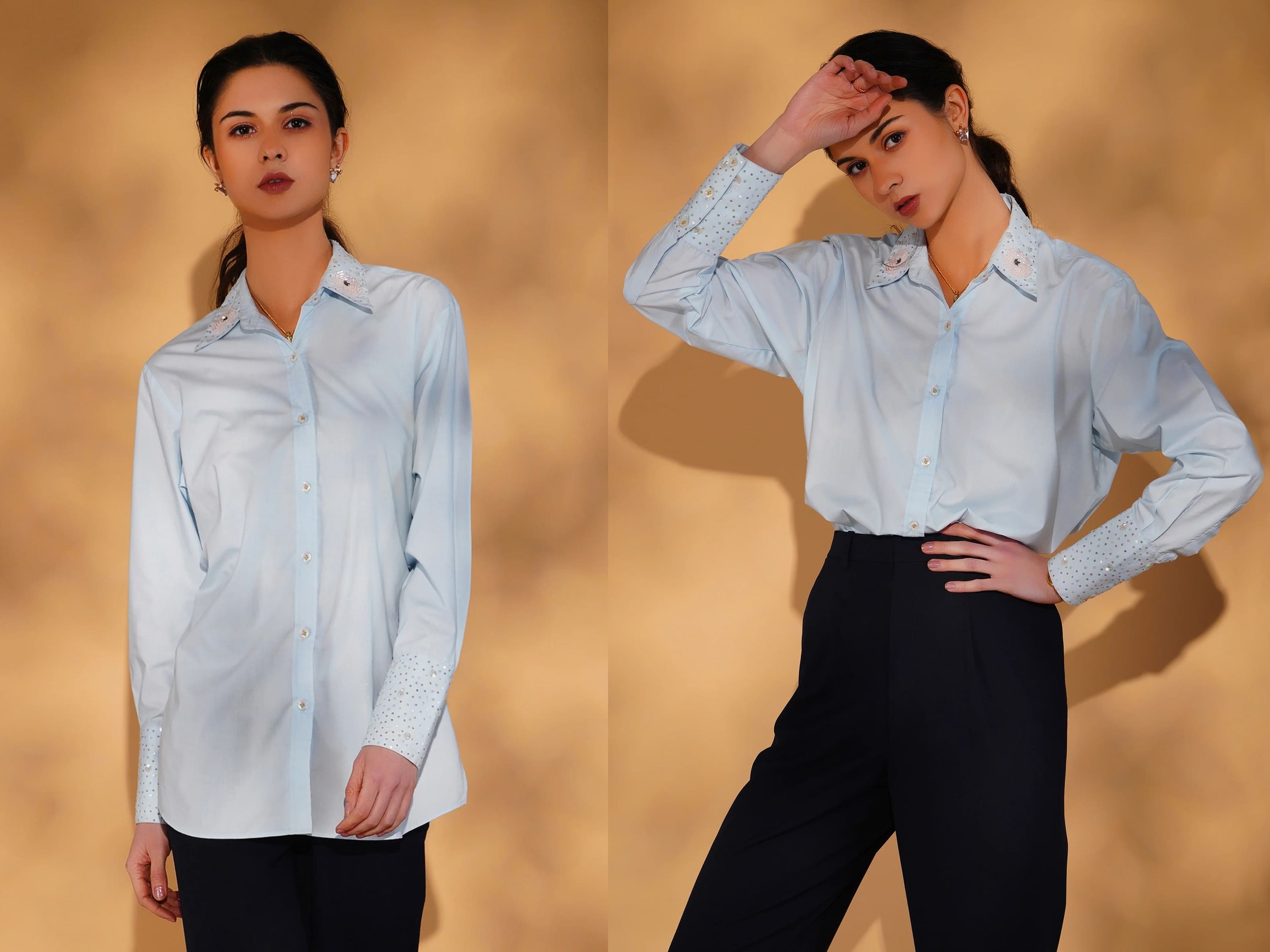 Woman wearing a light blue shirt and black pants against a beige background