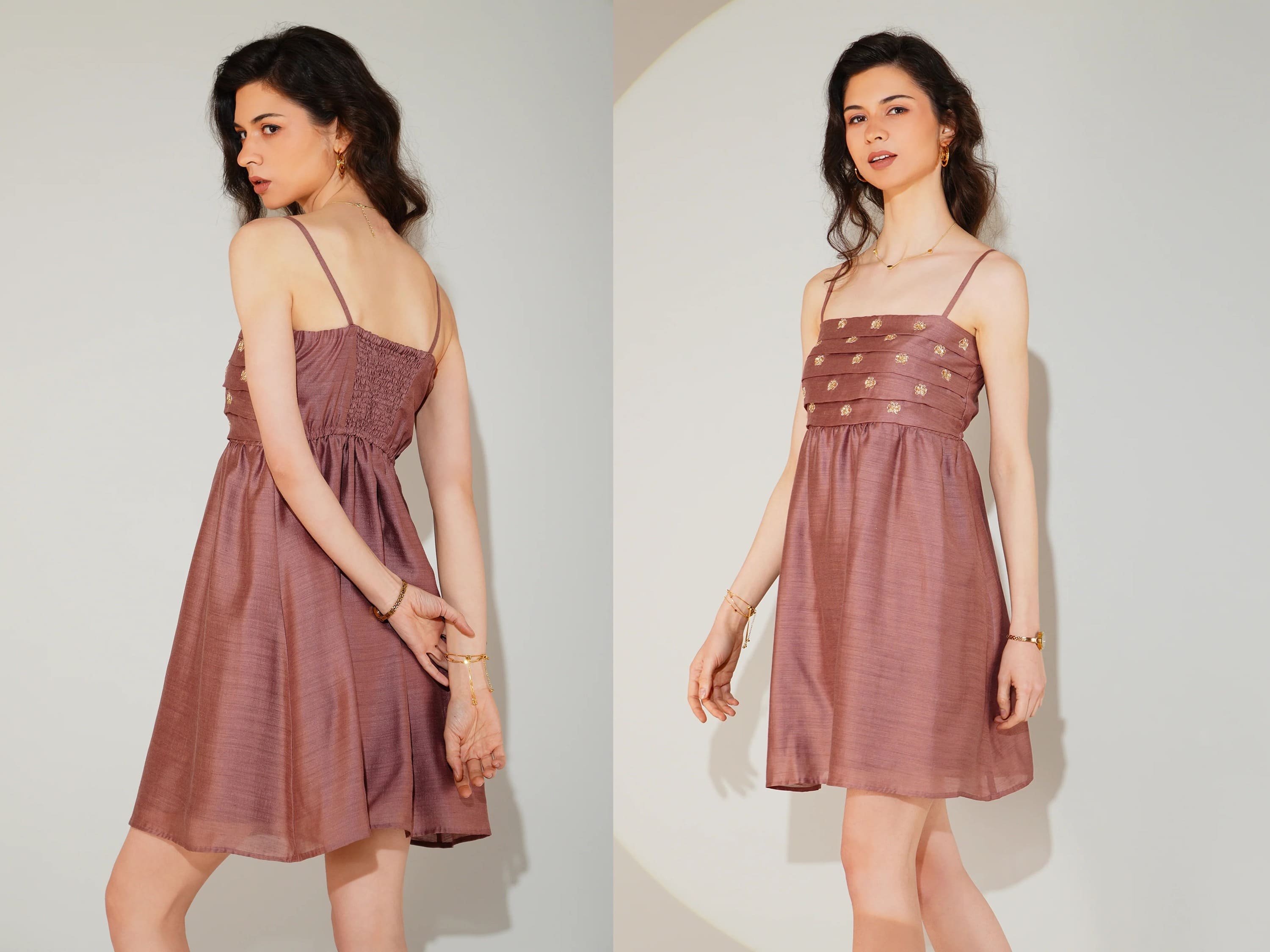 Woman wearing a mauve dress against a plain background