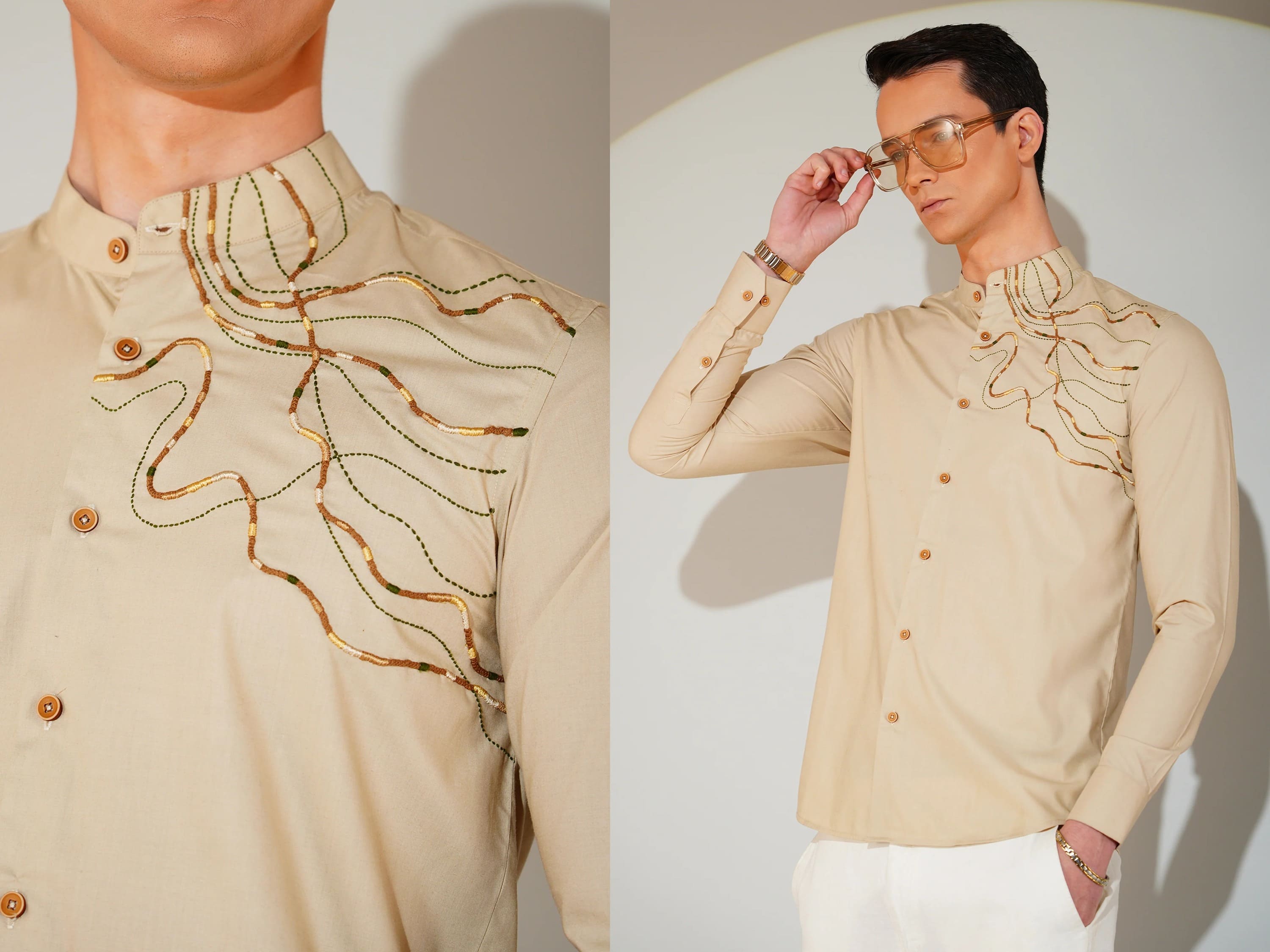 Man wearing a beige shirt with gold embroidery, posing against a plain background.