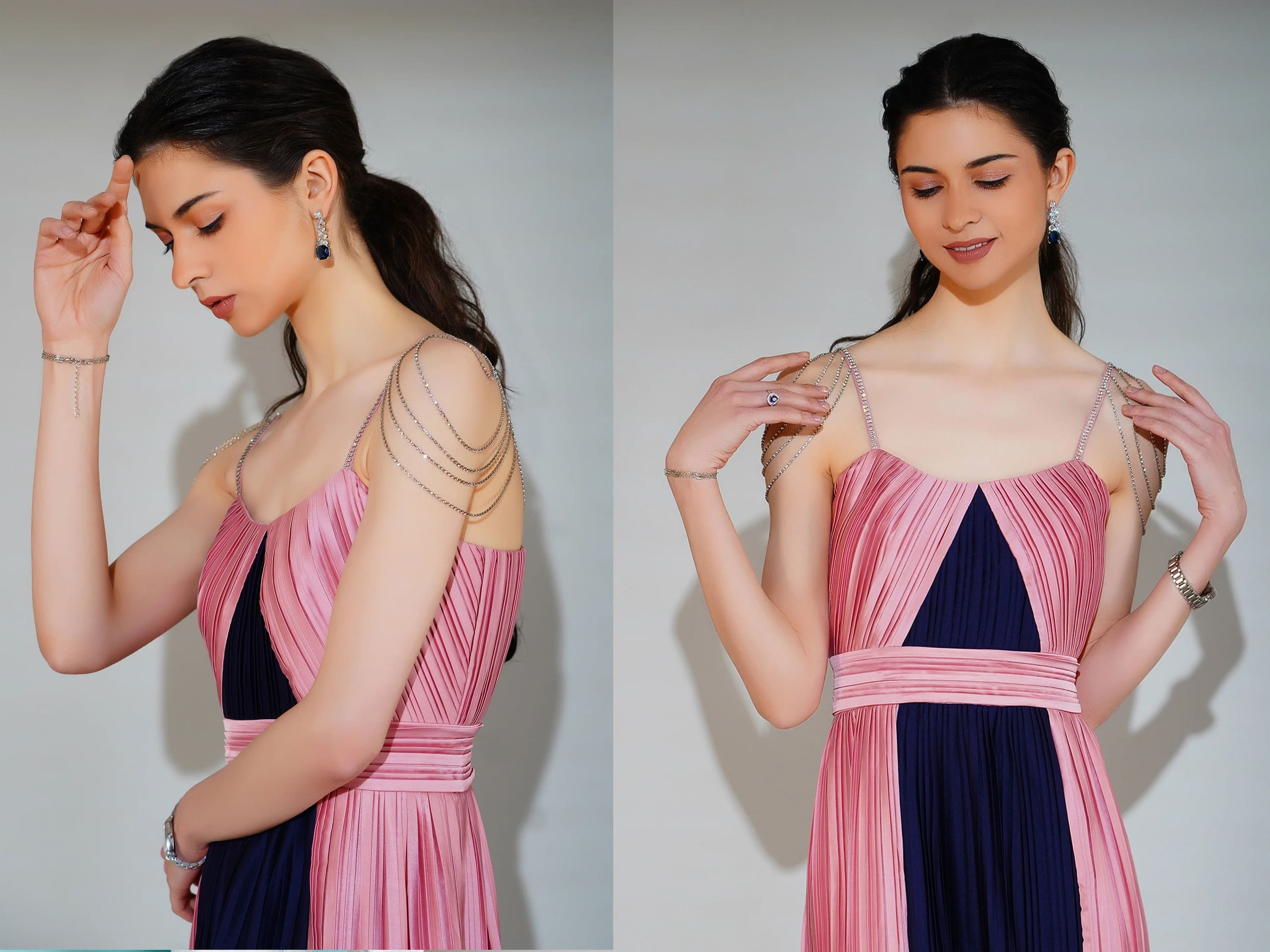 Woman wearing a pink and navy dress, adjusting straps against a plain background