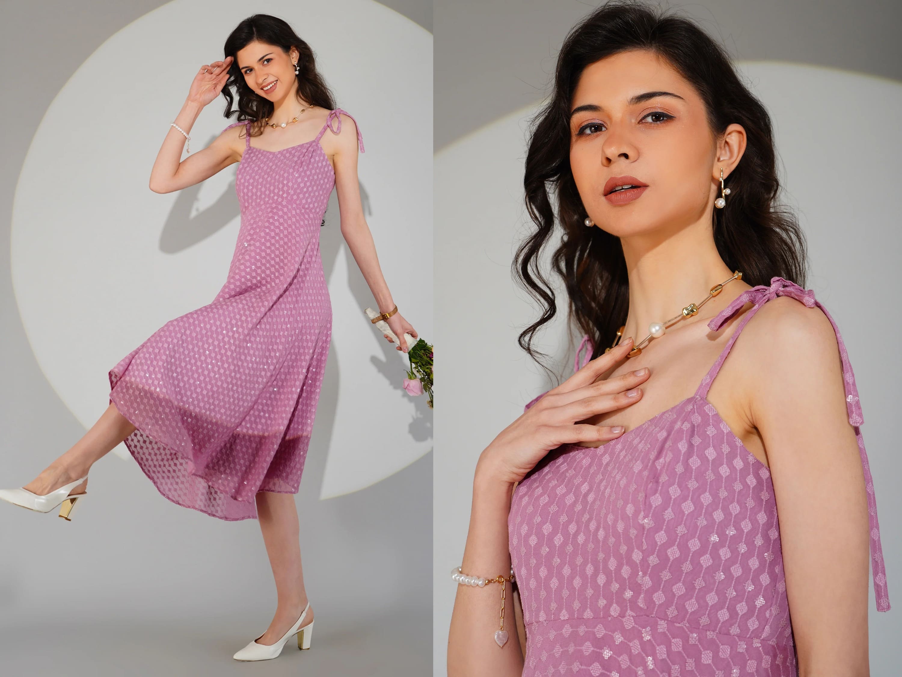 Woman wearing a pink dress with white polka dots, posing against a plain background.