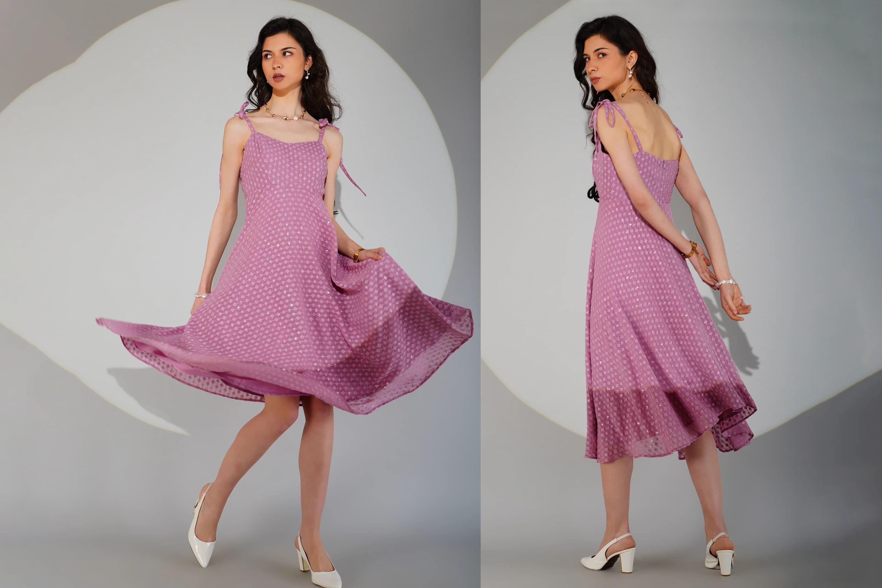 Woman wearing a purple dress with white polka dots on a gray background