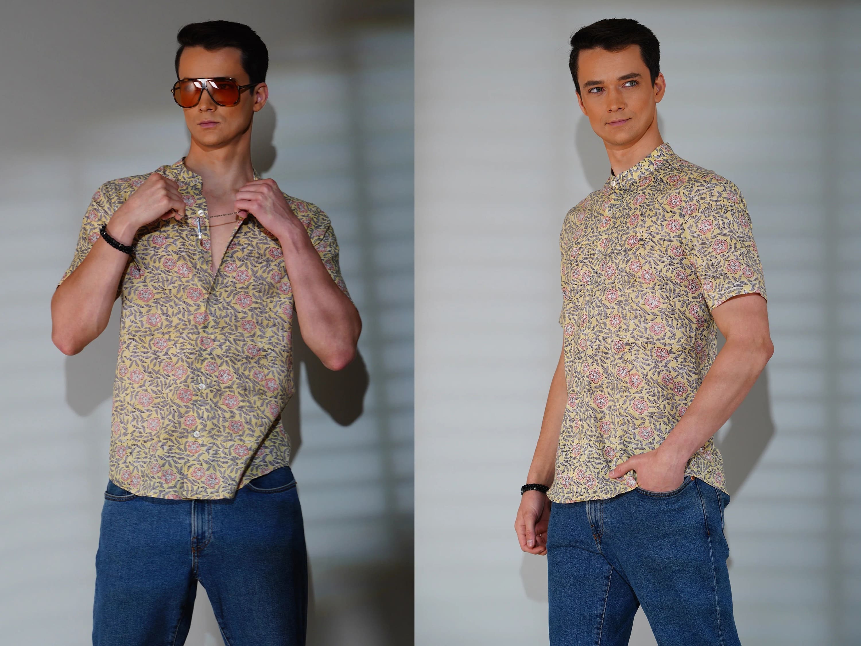 Man wearing a patterned shirt and blue jeans against a plain background