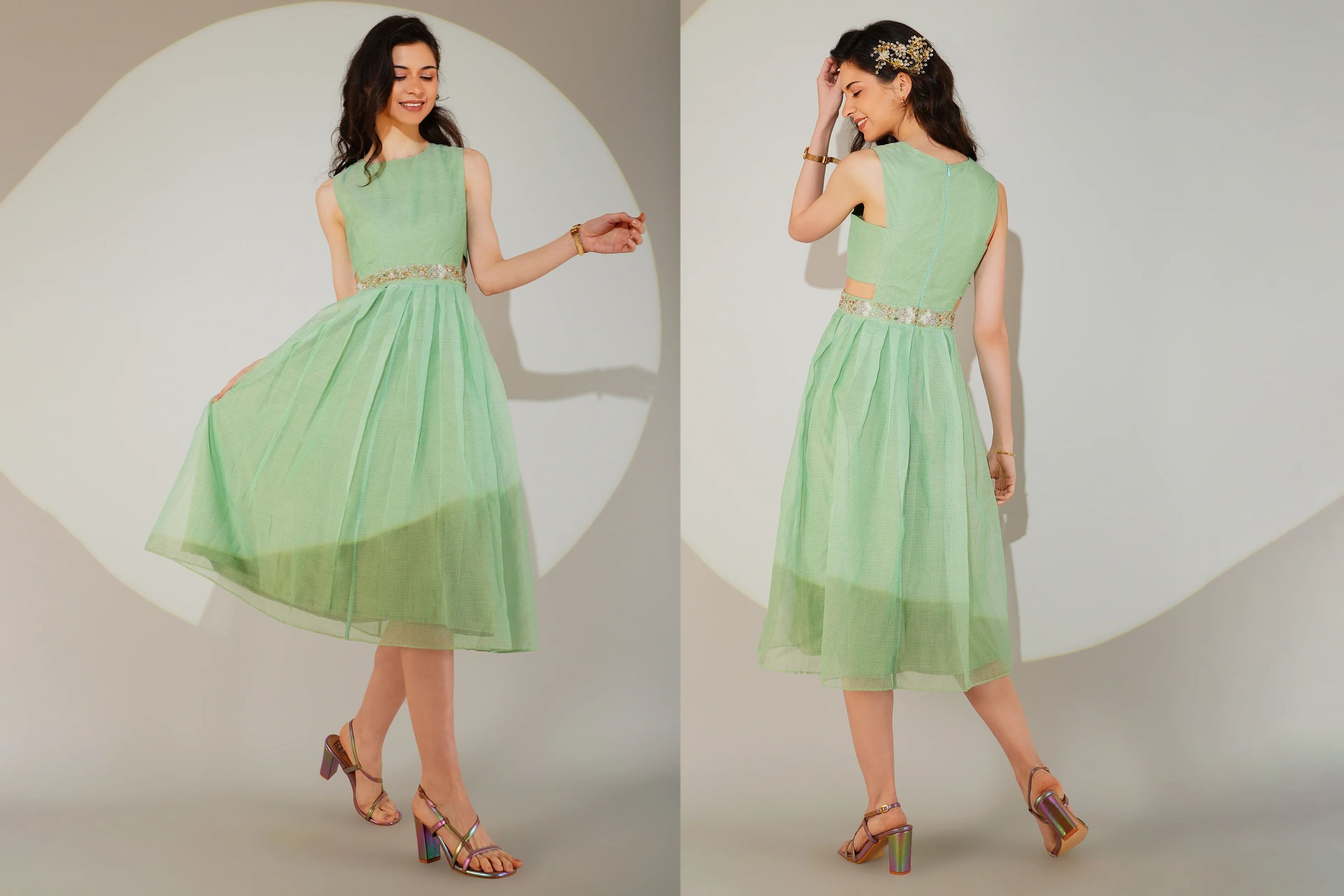 Woman wearing a light green dress with a subtle pattern on a plain background